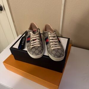 Authentic Gucci monograma Sneakers with Red and Blue Stripes.